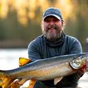 Portrait of Liam O'Connell, a seasoned Musky angler, holding a large Musky fish.